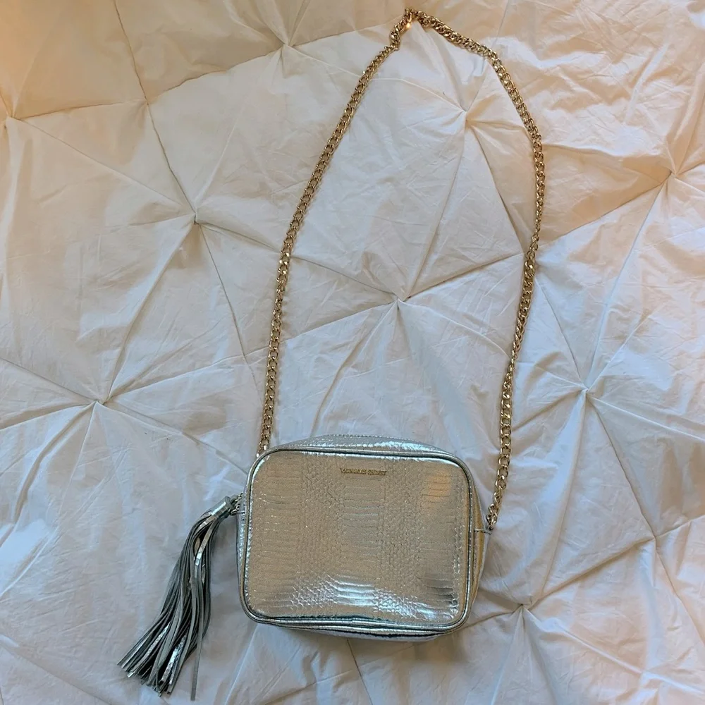 Victoria’s Secret cross body silver purse with tassel and gold chain NWOT